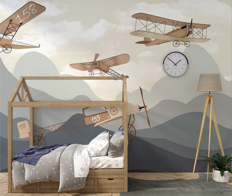 Vintage airplanes in muted brown tones soaring above layered mountain ranges in shades of blue-gray and beige. The retro aircraft designs emphasize an early aviation theme, while the subdued color palette gives a nostalgic, calm atmosphere. The background includes soft clouds, complementing the overall vintage aesthetic.