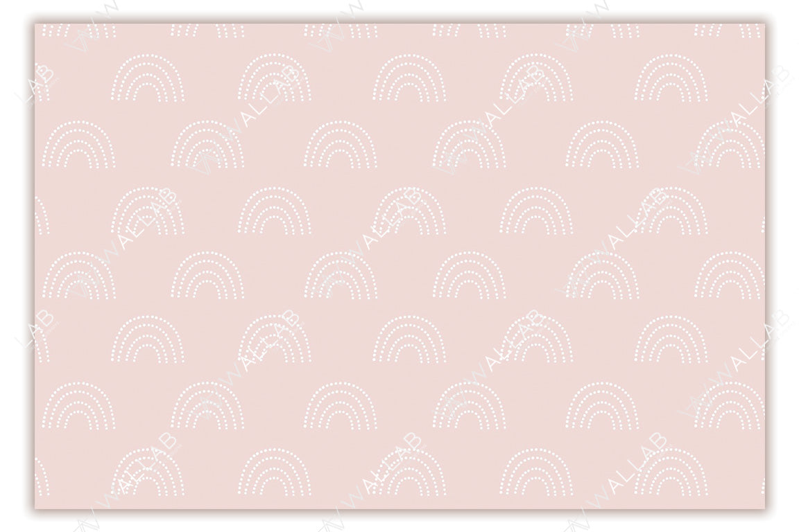 A soft blush-colored background adorned with a repeating pattern of white, dotted rainbows. The delicate pastel tones and minimalistic design create a calm and playful aesthetic, ideal for nurseries or children's rooms. The symmetrical layout adds to the overall soothing appeal.