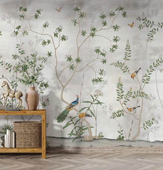 An elegant and nature-inspired mural with slender tree branches, blooming flowers, and colorful birds gracefully perched throughout. The backdrop is soft and muted, enhancing the delicate beauty of the scene. Butterflies and lush foliage add to the serene and enchanting atmosphere, perfect for creating a tranquil ambiance.