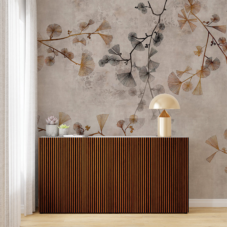 A subtle wallpaper mural featuring delicate branches adorned with ginkgo leaves in warm tones of beige, gold, and brown on a textured, neutral background. The design offers a soft, natural aesthetic, perfect for adding an understated elegance to interiors.