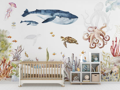 This hand-painted ocean scene showcases a vibrant underwater world with whales, turtles, octopuses, jellyfish, and various fish swimming amidst colorful coral reefs and sea plants. The watercolor effect adds a delicate, artistic touch to the lively marine ecosystem.