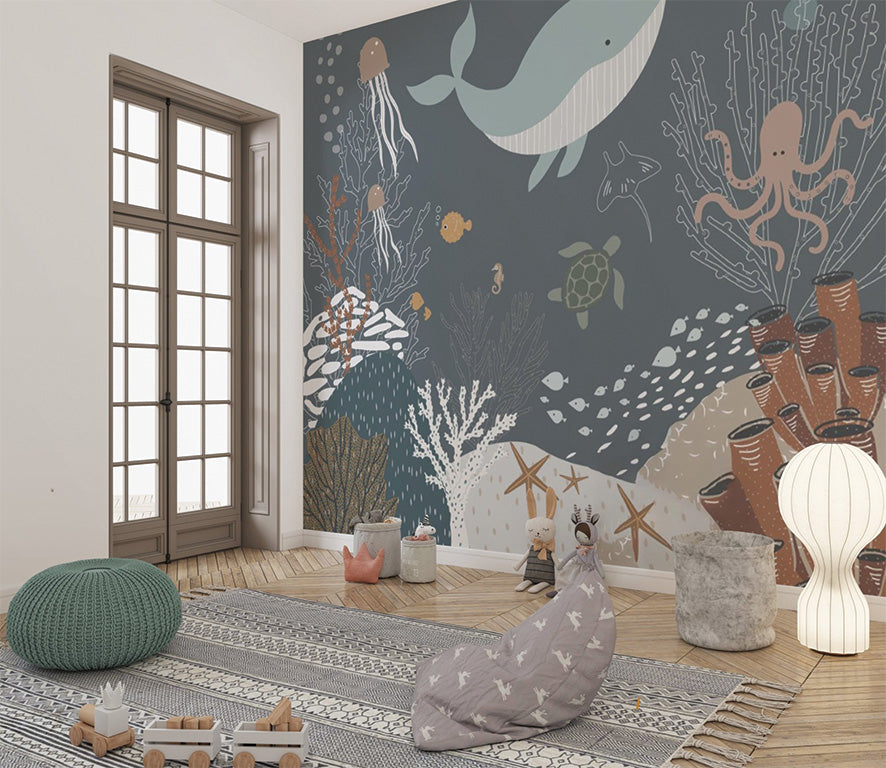 This charming underwater scene features a variety of sea creatures, including a whale, jellyfish, an octopus, a turtle, and small fish, swimming amidst coral reefs, sea stars, and sponges. The muted blue and earthy tones create a calming, whimsical depiction of marine life, ideal for children's illustrations or ocean-themed designs.