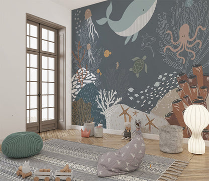 This charming underwater scene features a variety of sea creatures, including a whale, jellyfish, an octopus, a turtle, and small fish, swimming amidst coral reefs, sea stars, and sponges. The muted blue and earthy tones create a calming, whimsical depiction of marine life, ideal for children's illustrations or ocean-themed designs.