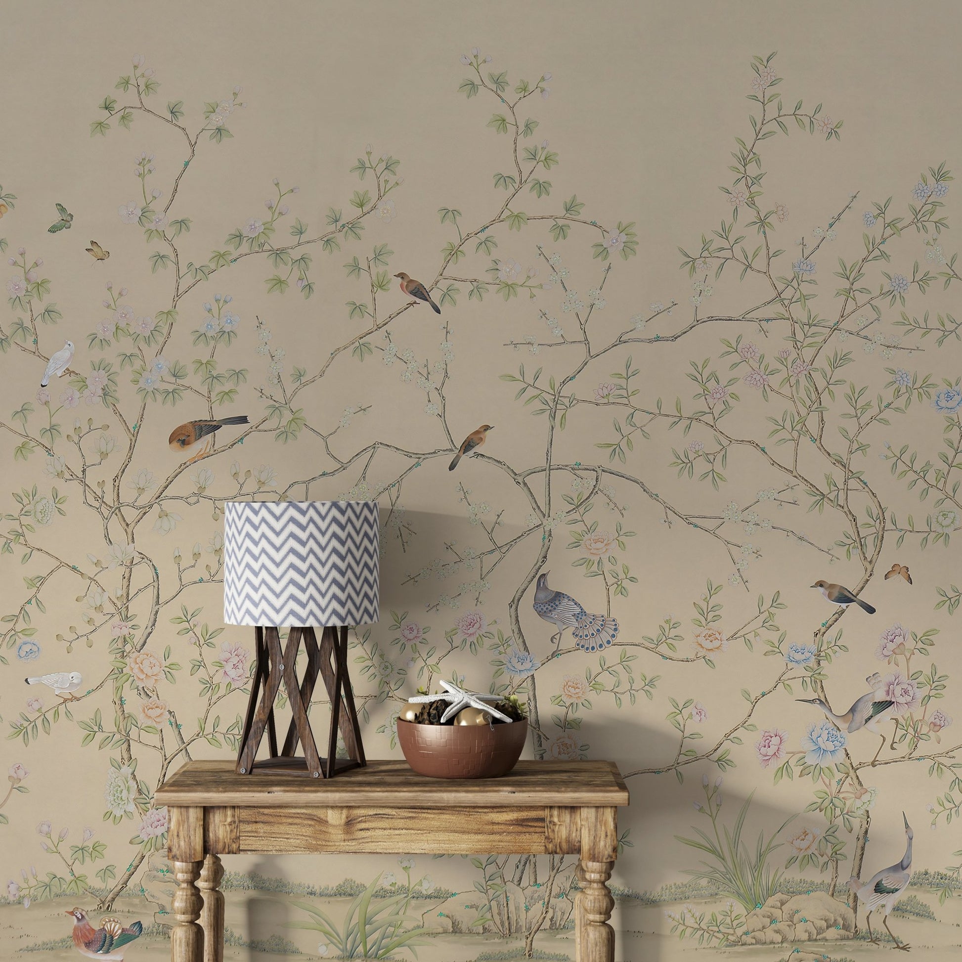 A detailed and elegant wallpaper featuring intertwining branches adorned with pastel blossoms and delicate green leaves against a soft beige background. Small birds in various poses are perched on the branches or fluttering nearby, adding a sense of life and movement to the tranquil, nature-inspired design.